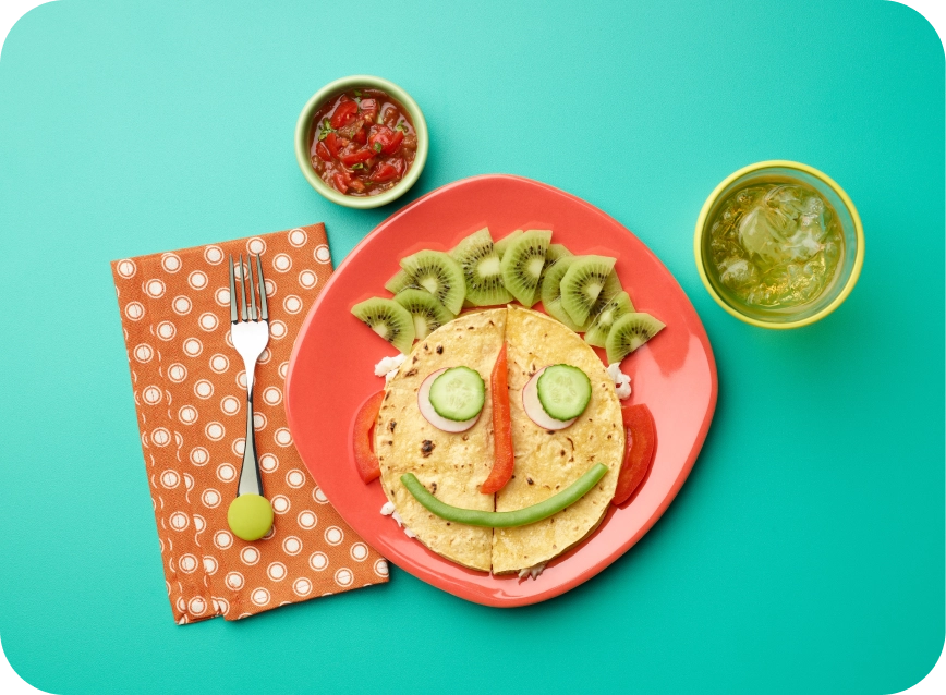 Photo of a taco plate with toppings arranged as a smile